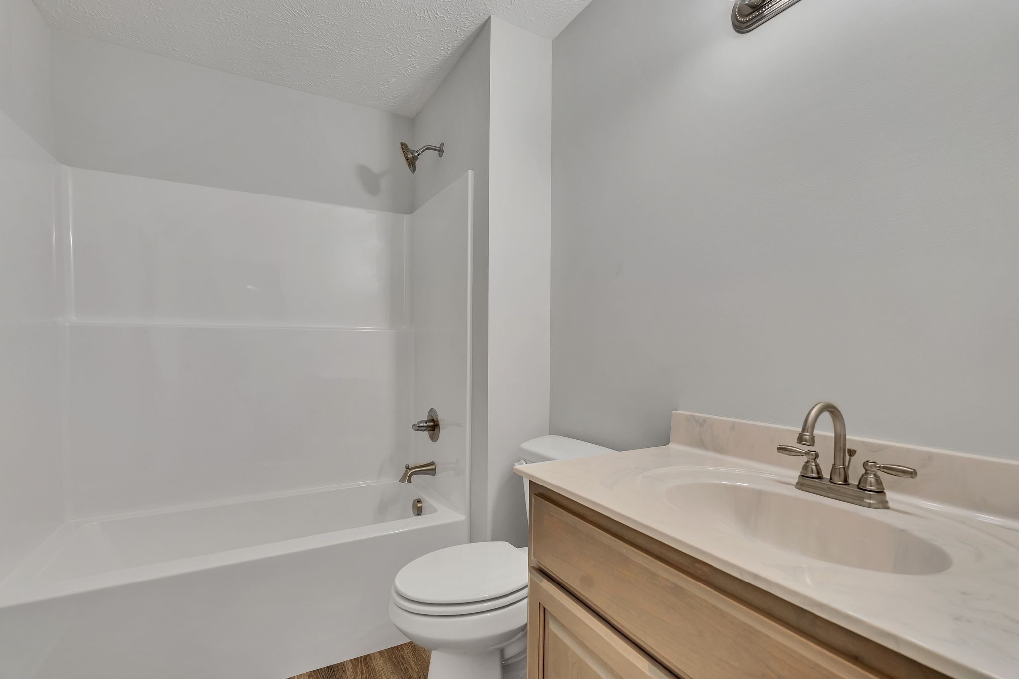 563 Paynes Church Road Estill Springs, TN 37330 - Photo 23 of 31 a bathroom with a granite countertop toilet a sink and a bathtub