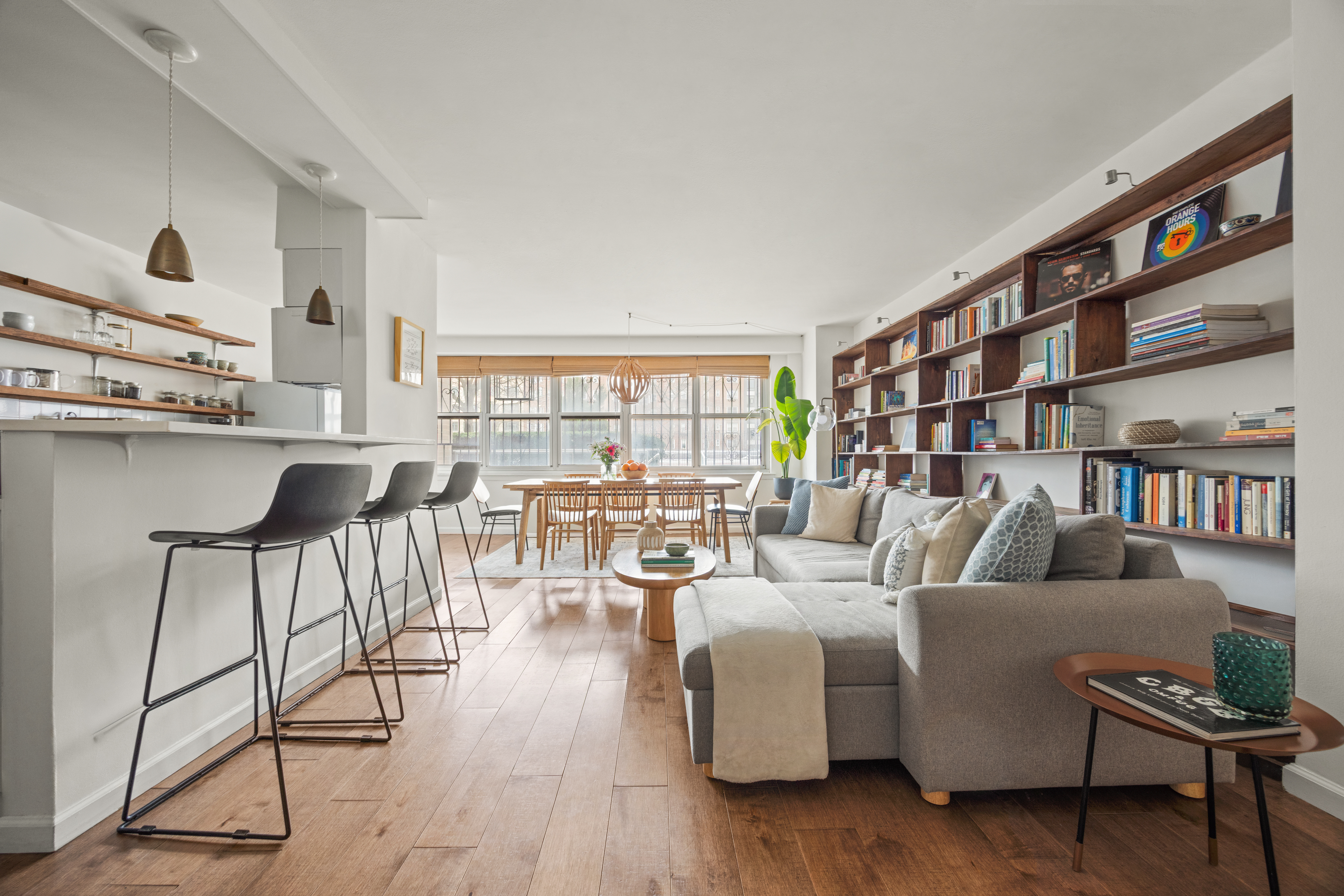 135 Ocean Parkway, Unit 1M Brooklyn, NY 11218 - Photo 1 of 11 a living room with furniture and a book shelf