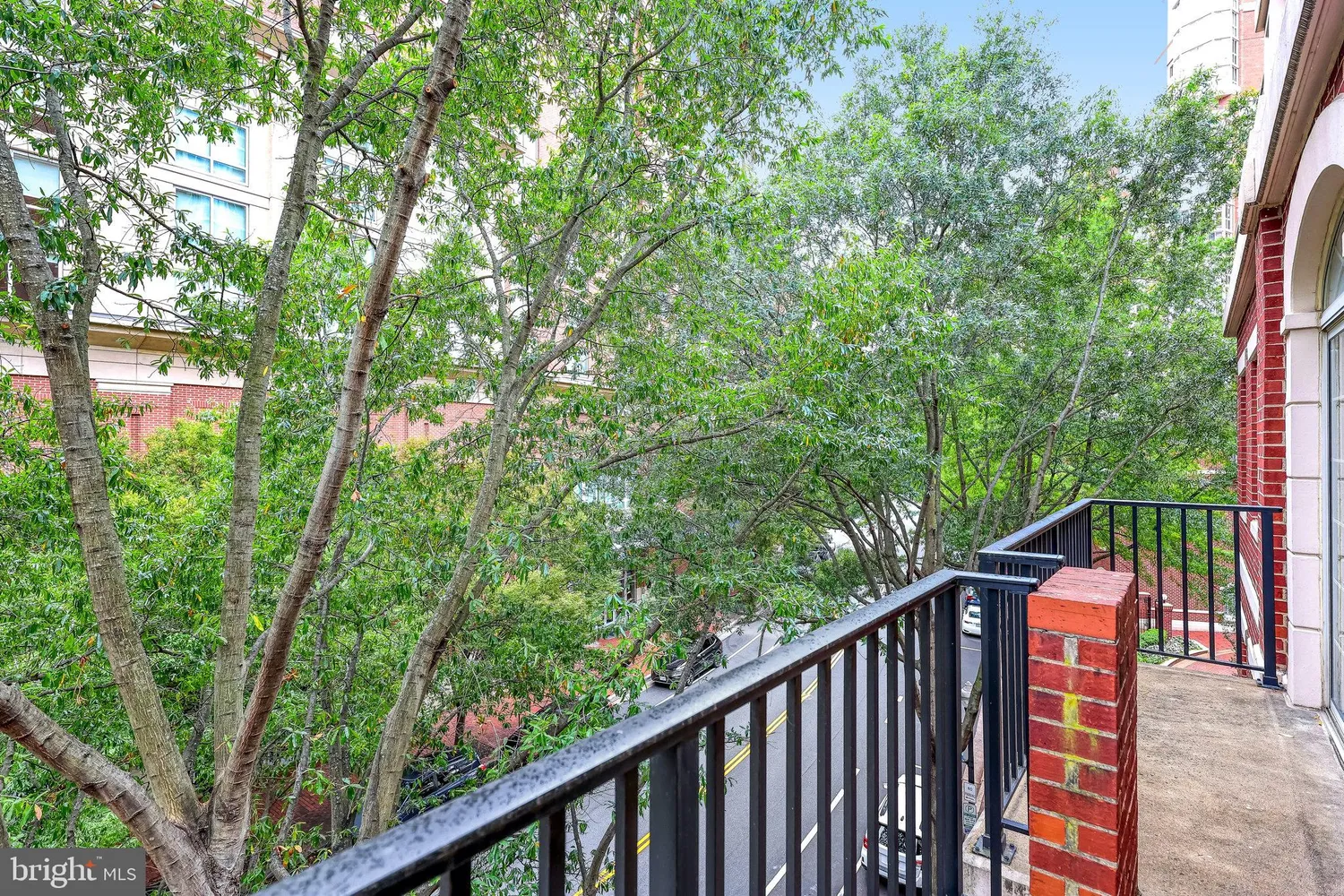 a balcony with wooden floor and trees