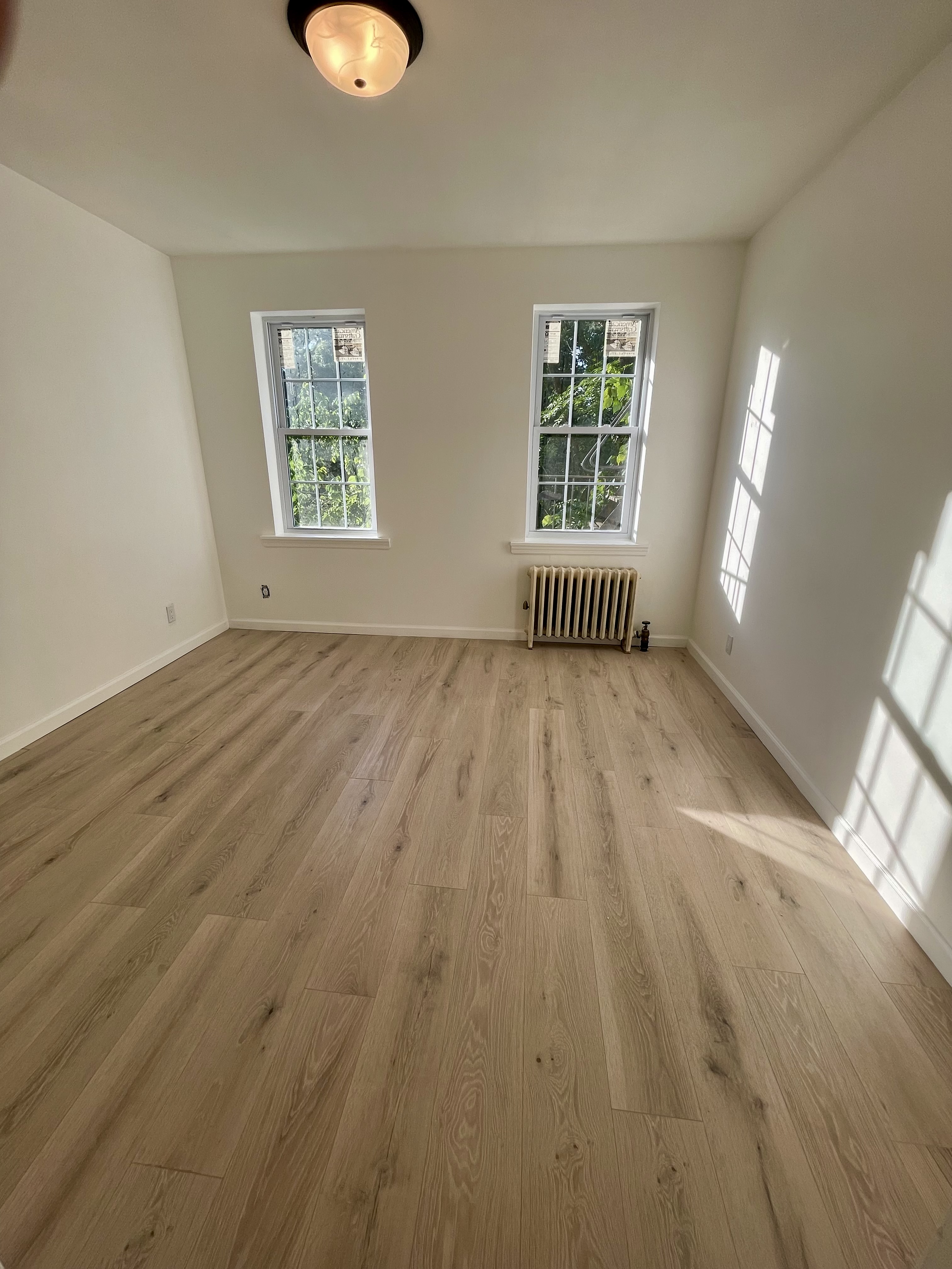 3194 Webster Avenue Bronx, NY 10467 - Photo 9 of 23 an empty room with wooden floor and windows