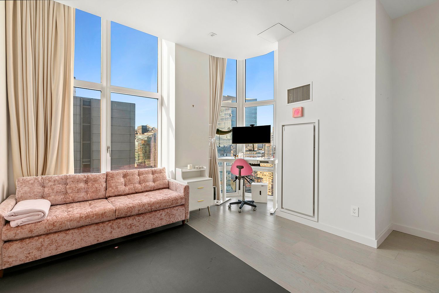 555 West 59th Street, Unit PHA Manhattan, NY 10019 - Photo 13 of 20 a living room with furniture and a flat screen tv