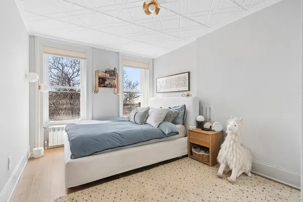 a bedroom with a bed and a window