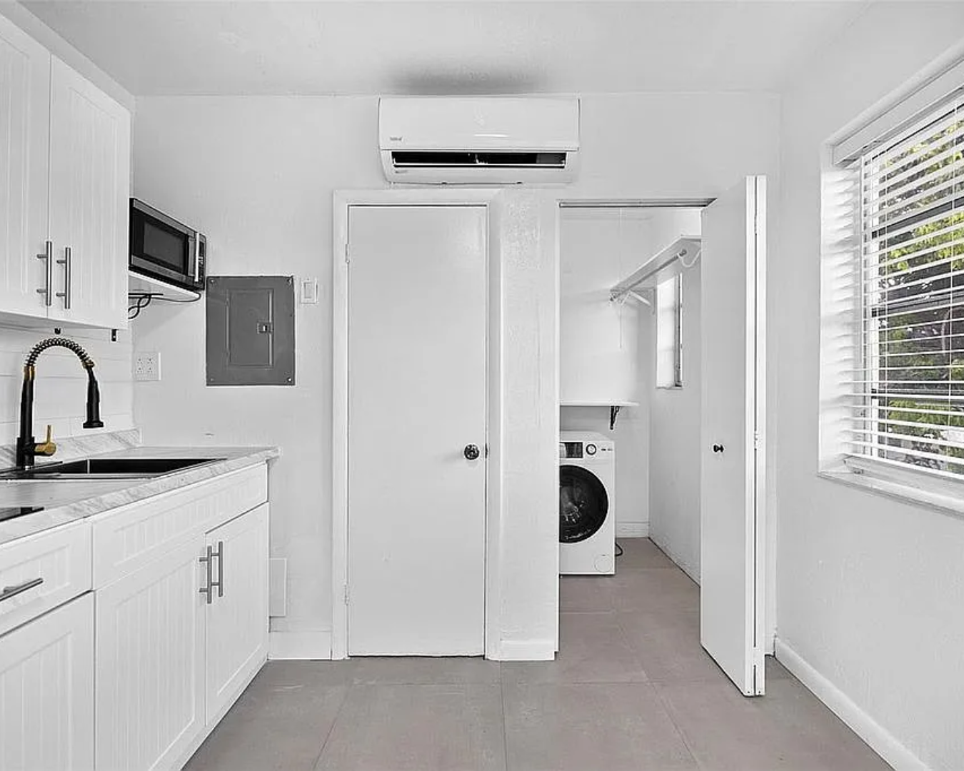 2822 Pine Tree Drive Miami Beach, FL 33140 - Photo 18 of 21 a bathroom with a granite countertop sink and a mirror