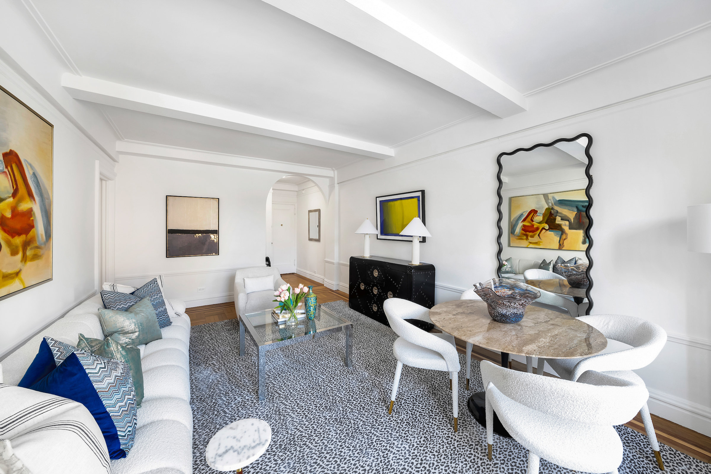 51 East 90th Street, Unit 8D Manhattan, NY 10128 - Photo 2 of 10 a living room with furniture and wooden floor