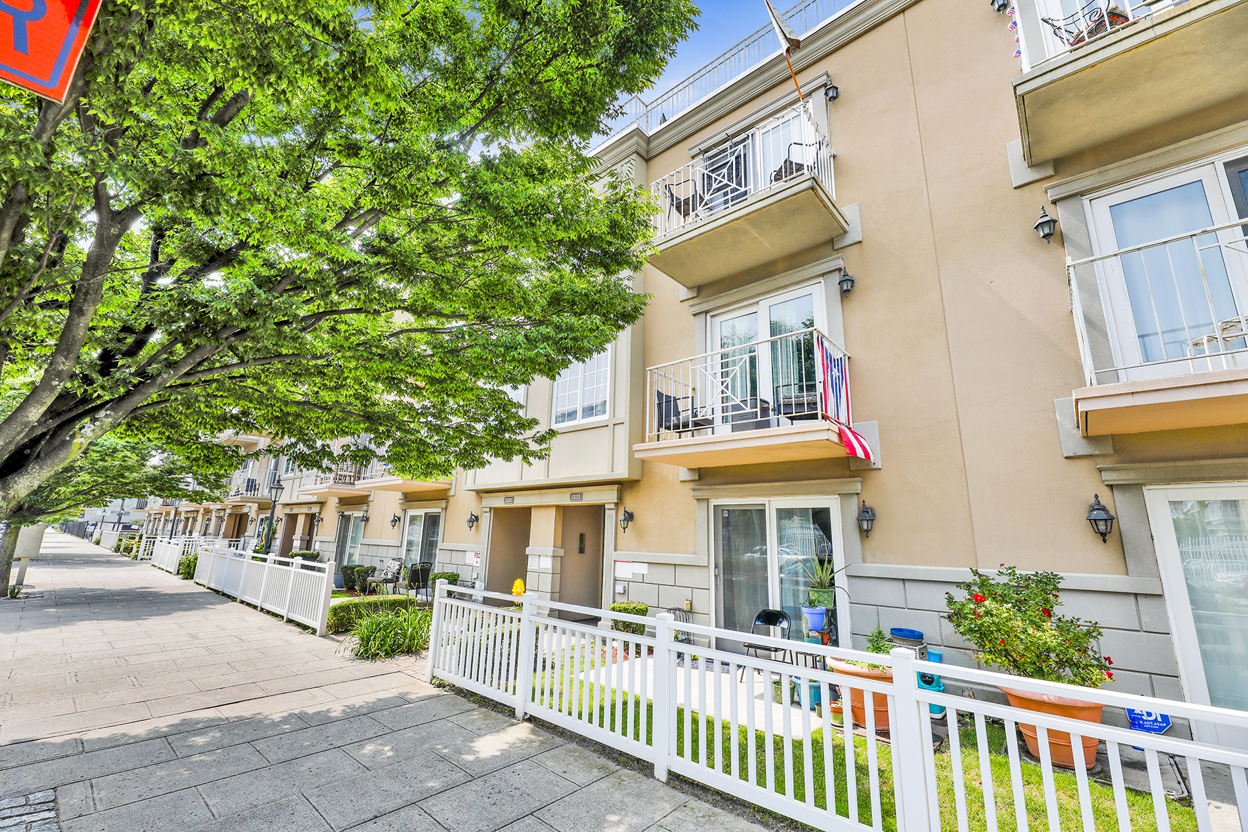 10220 Rockaway Beach Boulevard, Unit 3C Queens, NY 11694 - Photo 43 of 46 a view of a house with a small yard and a large tree