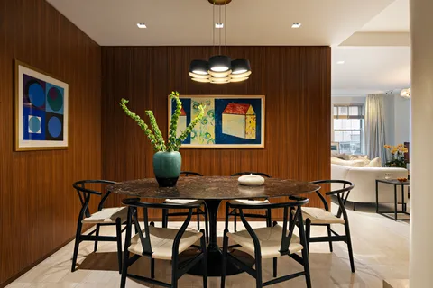 a view of a dining room with furniture and window