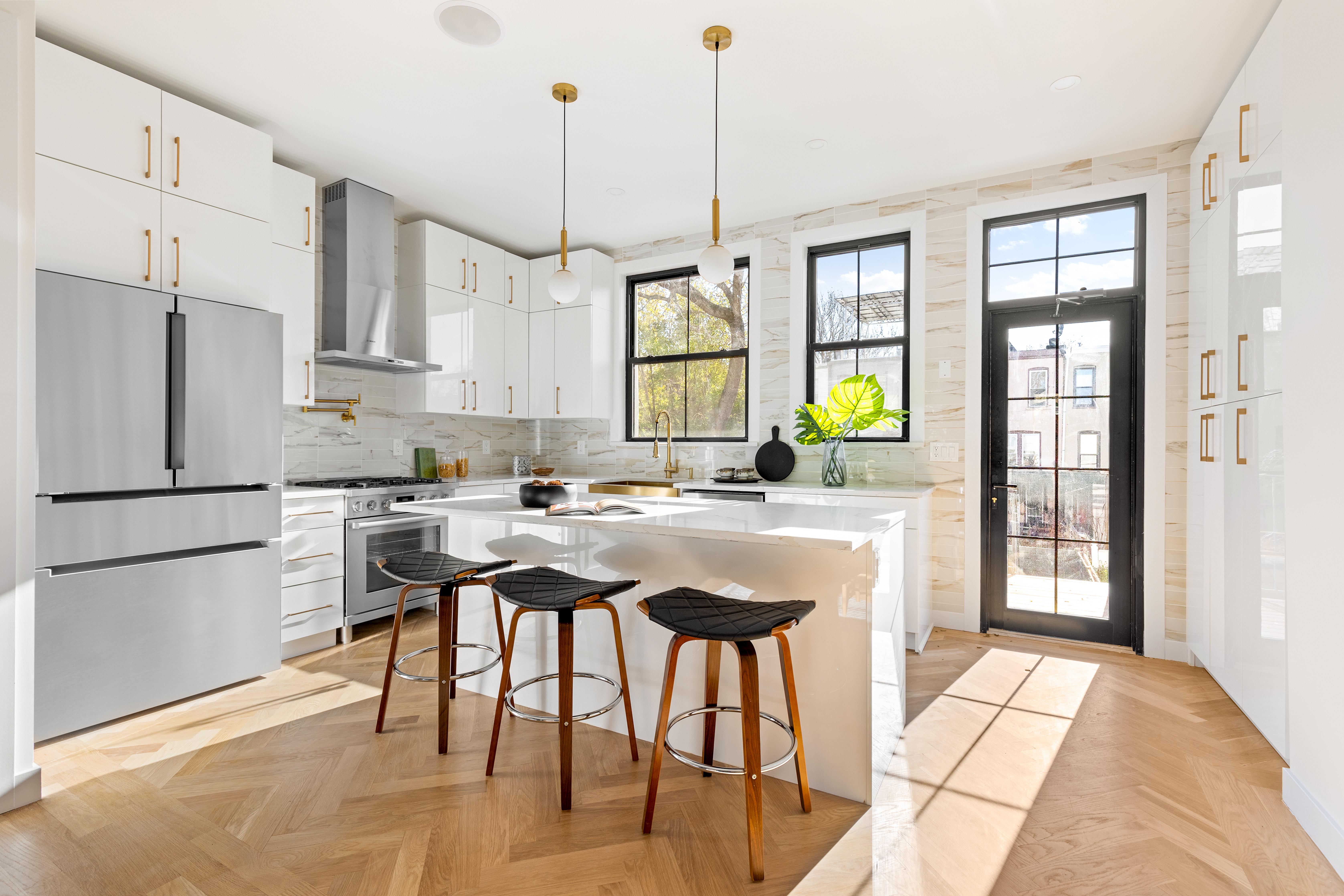 a kitchen with stainless steel appliances granite countertop sink stove and refrigerator