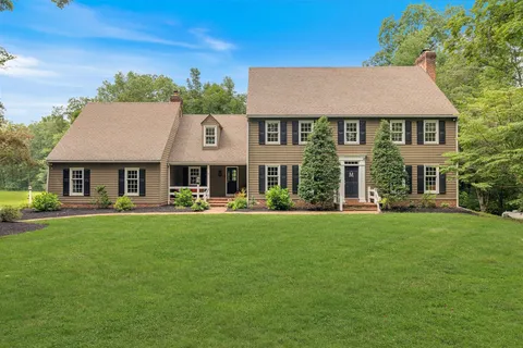 a front view of a house with a garden and porch