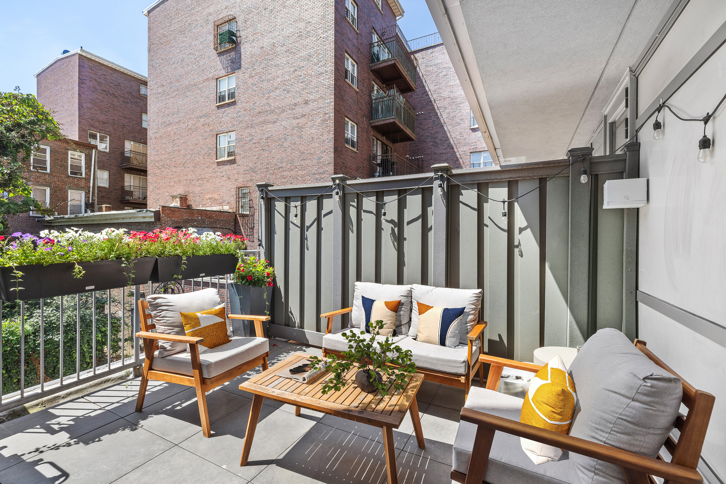 192 Spencer Street, Unit 3A Brooklyn, NY 11205 - Photo 2 of 12 a view of a patio with couches table and chairs and potted plants