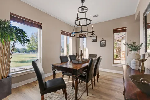 a view of a hallway with wooden floor and closet