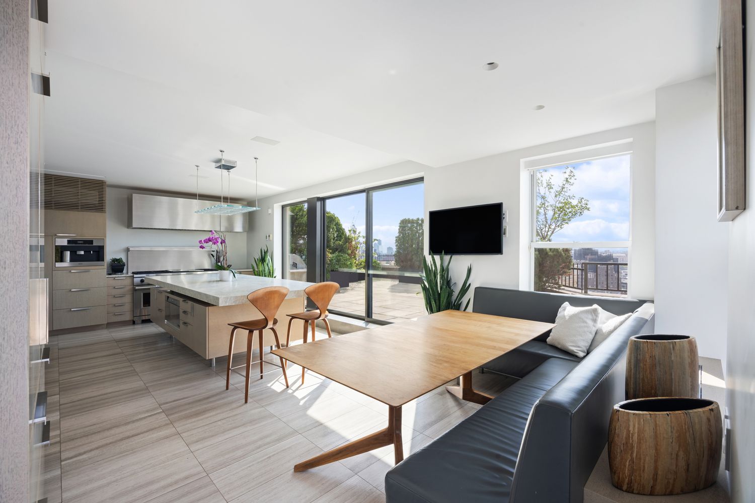 a living room with furniture wooden floor and a flat screen tv