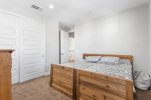 an aerial view of residential houses with outdoor space and lake view