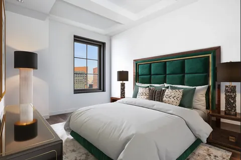 a bedroom with a bed and glass window