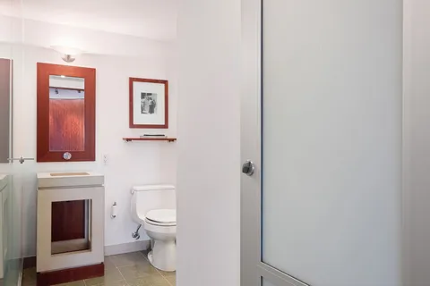 a bathroom with a shower and a glass door