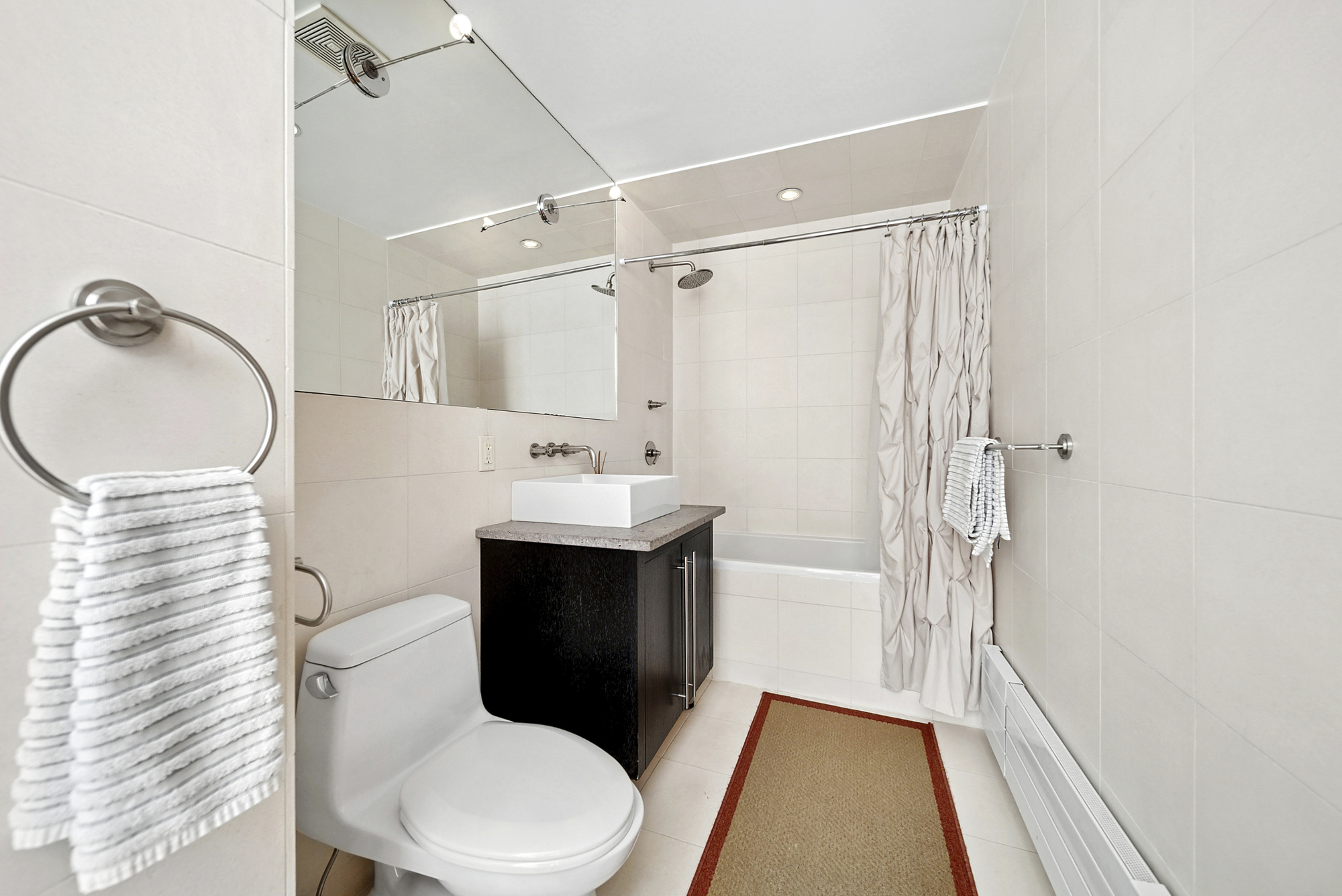 331 East 8th Street, Unit 2 Manhattan, NY 10009 - Photo 6 of 12 a bathroom with a sink toilet and shower