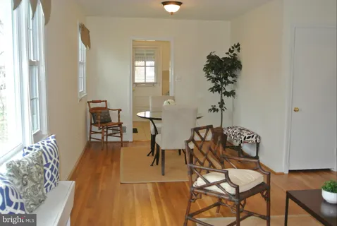 a dining room with furniture and wooden floor