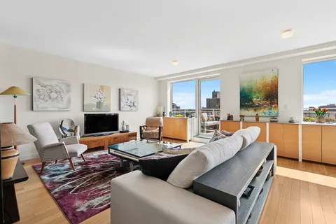a living room with furniture kitchen view and a fireplace