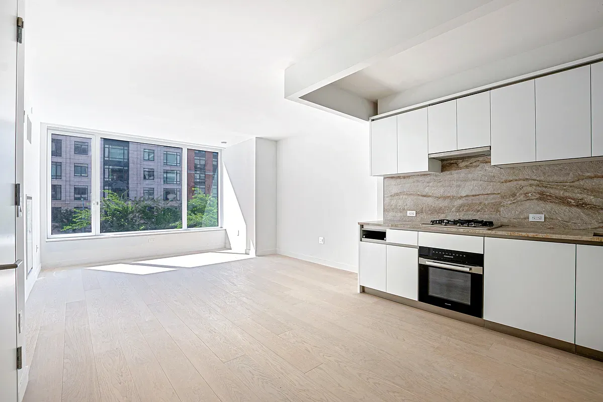 a kitchen with stainless steel appliances granite countertop a stove and a refrigerator
