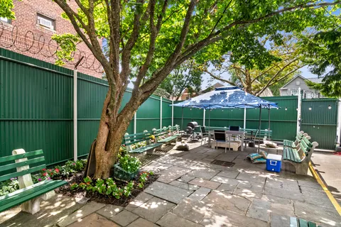 a view of a chair and tables in the backyard of the house