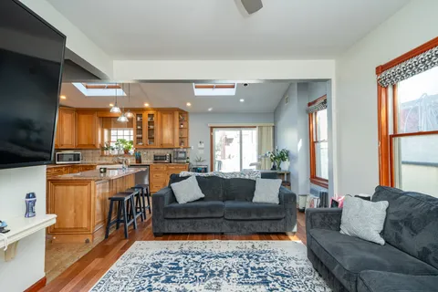 a living room with furniture wooden floor and a flat screen tv