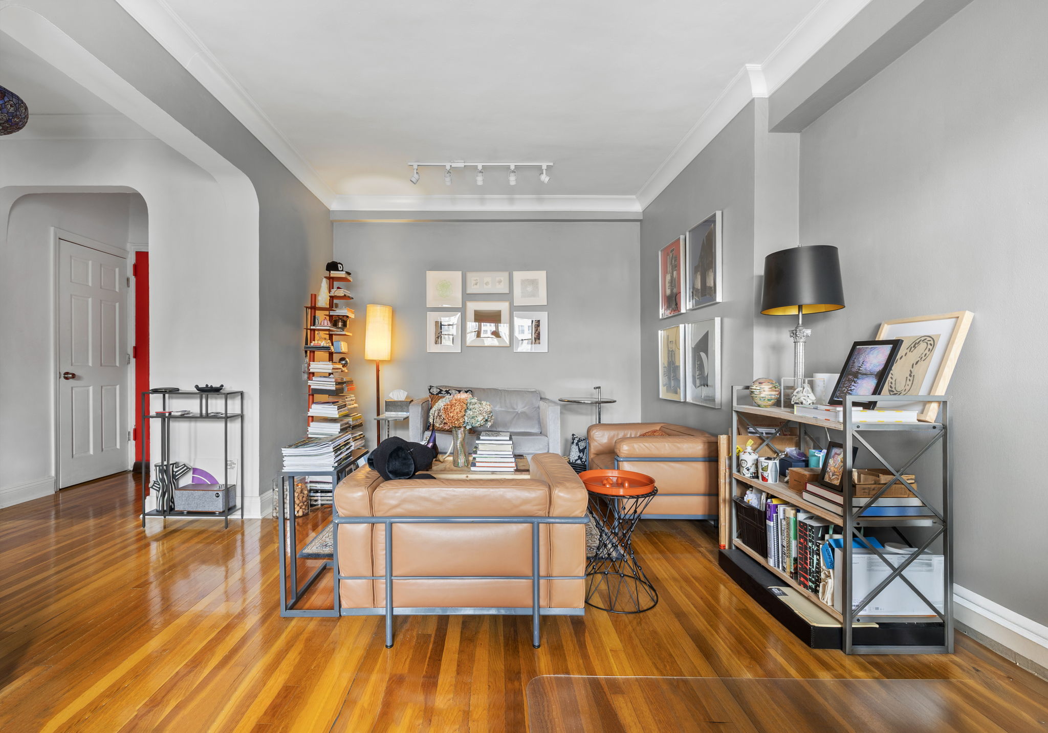 a bedroom with furniture and a wooden floor