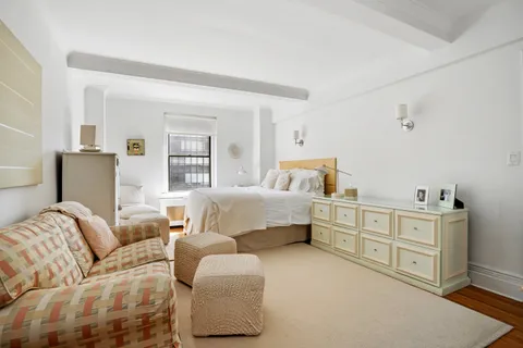 a bedroom with furniture and baby crib