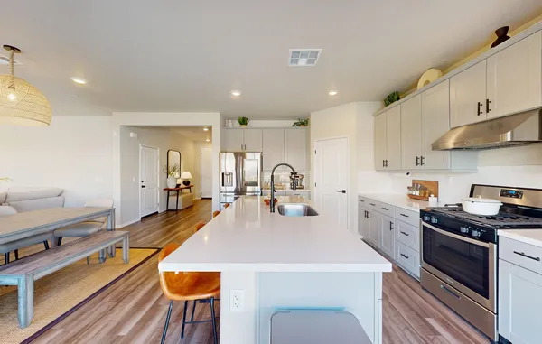a kitchen with stainless steel appliances a sink stove and cabinets