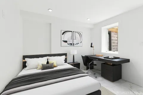 a bedroom with a bed and a table