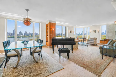 a living room with furniture a table and chairs