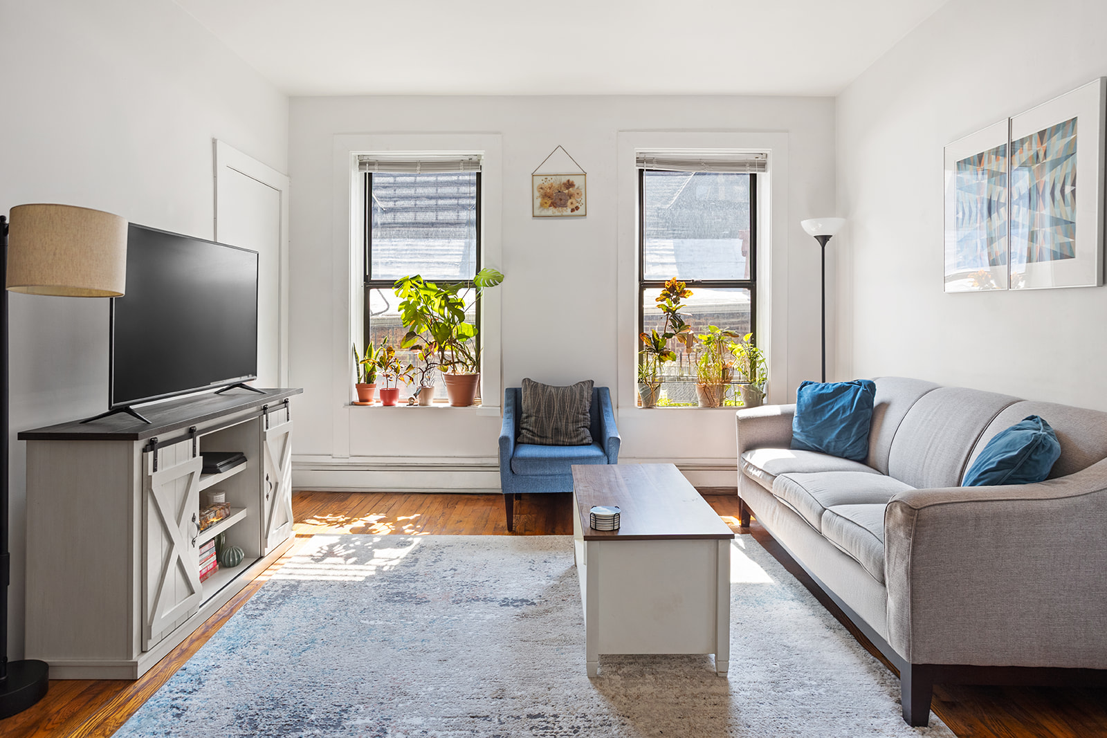 126 Sterling Place, Unit 2C Brooklyn, NY 11217 - Photo 2 of 8 a living room with furniture and a flat screen tv