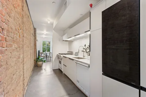 a kitchen with cabinets and window