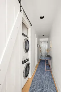 a view of a hallway with washer and dryer