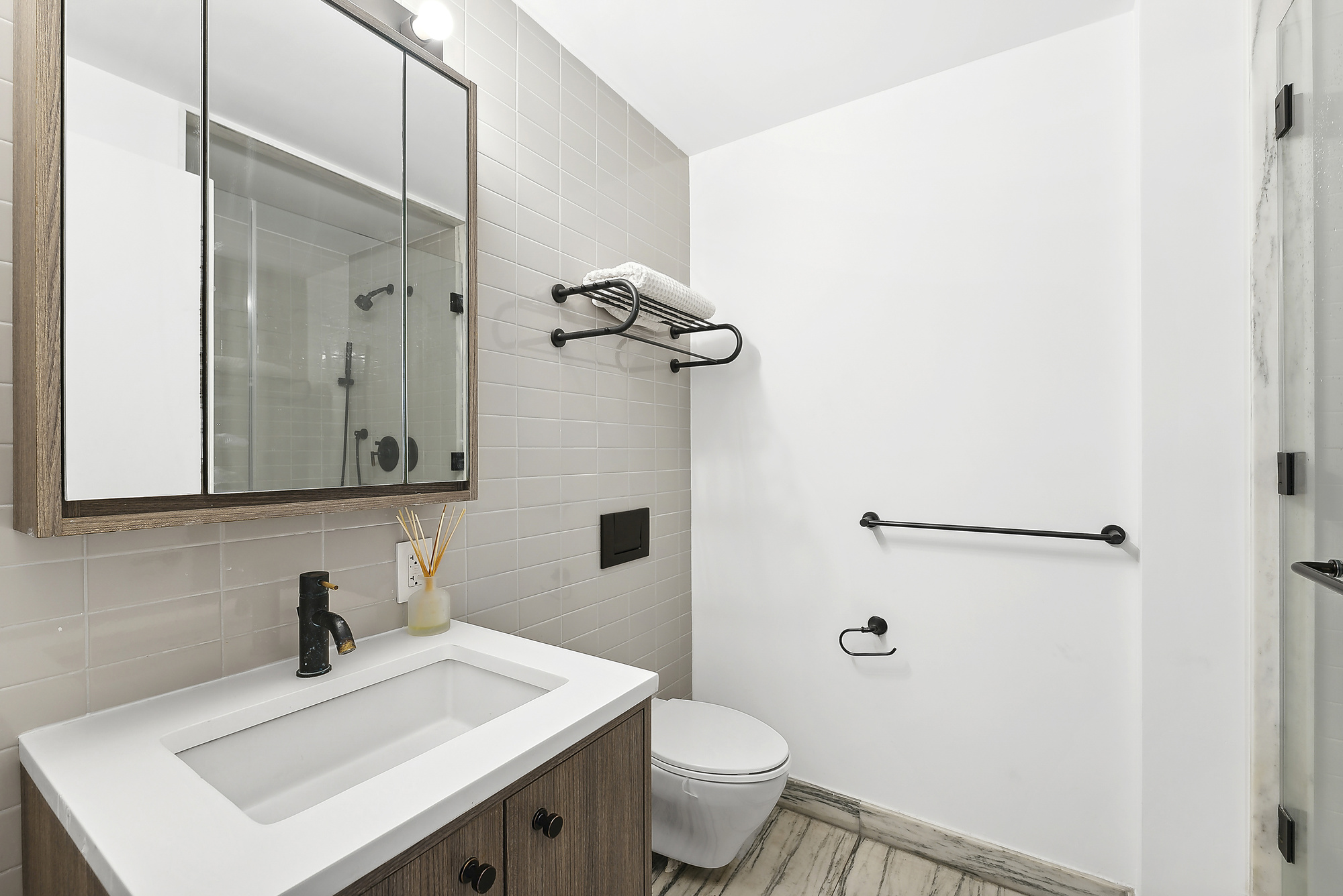 175 West 95th Street, Unit 18G Manhattan, NY 10025 - Photo 7 of 14 a bathroom with a sink vanity mirror and toilet
