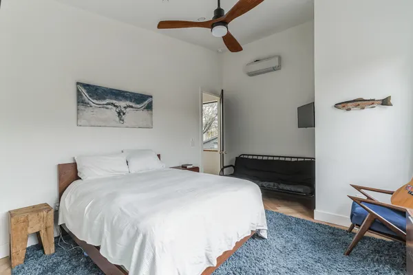 a bedroom with a bed and a chair