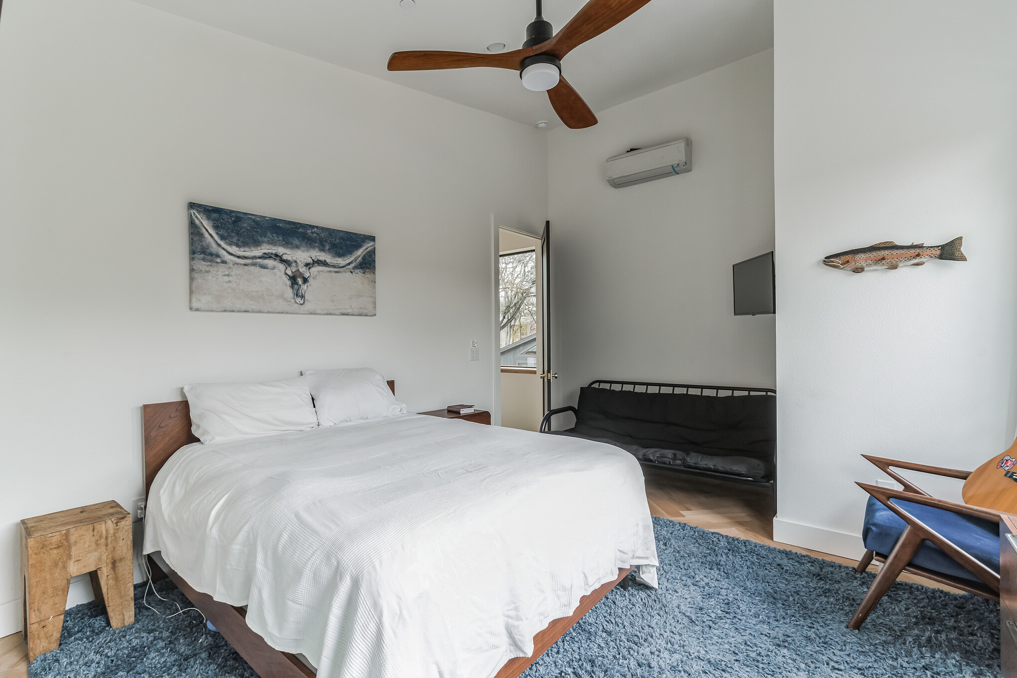 107 Blue Ridge Trail Austin, TX 78746 - Photo 25 of 38 a bedroom with a bed and a chair