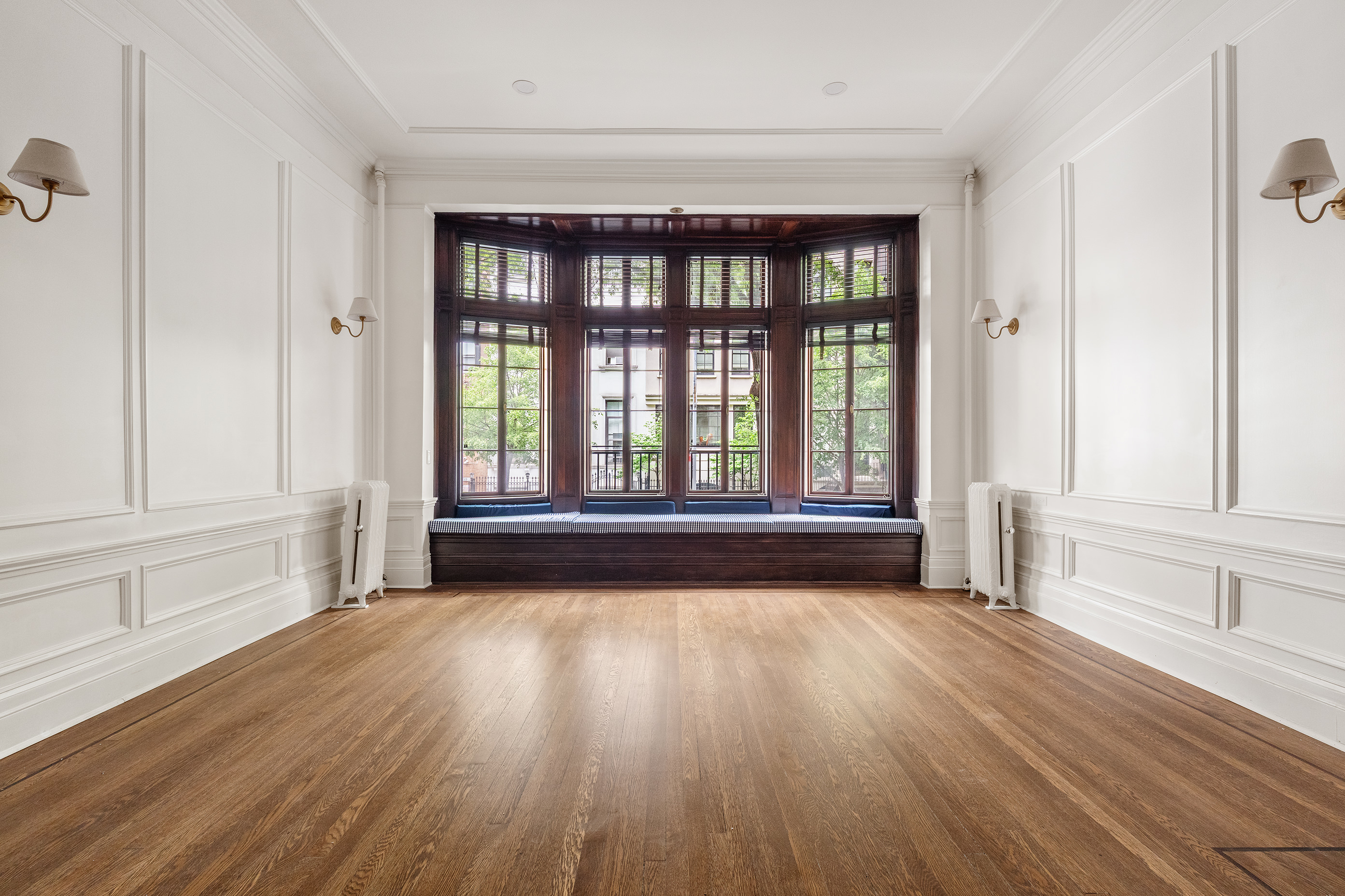 129 East 61st Street, Unit 3 Manhattan, NY 10065 - Photo 2 of 13 an empty room with wooden floor and windows