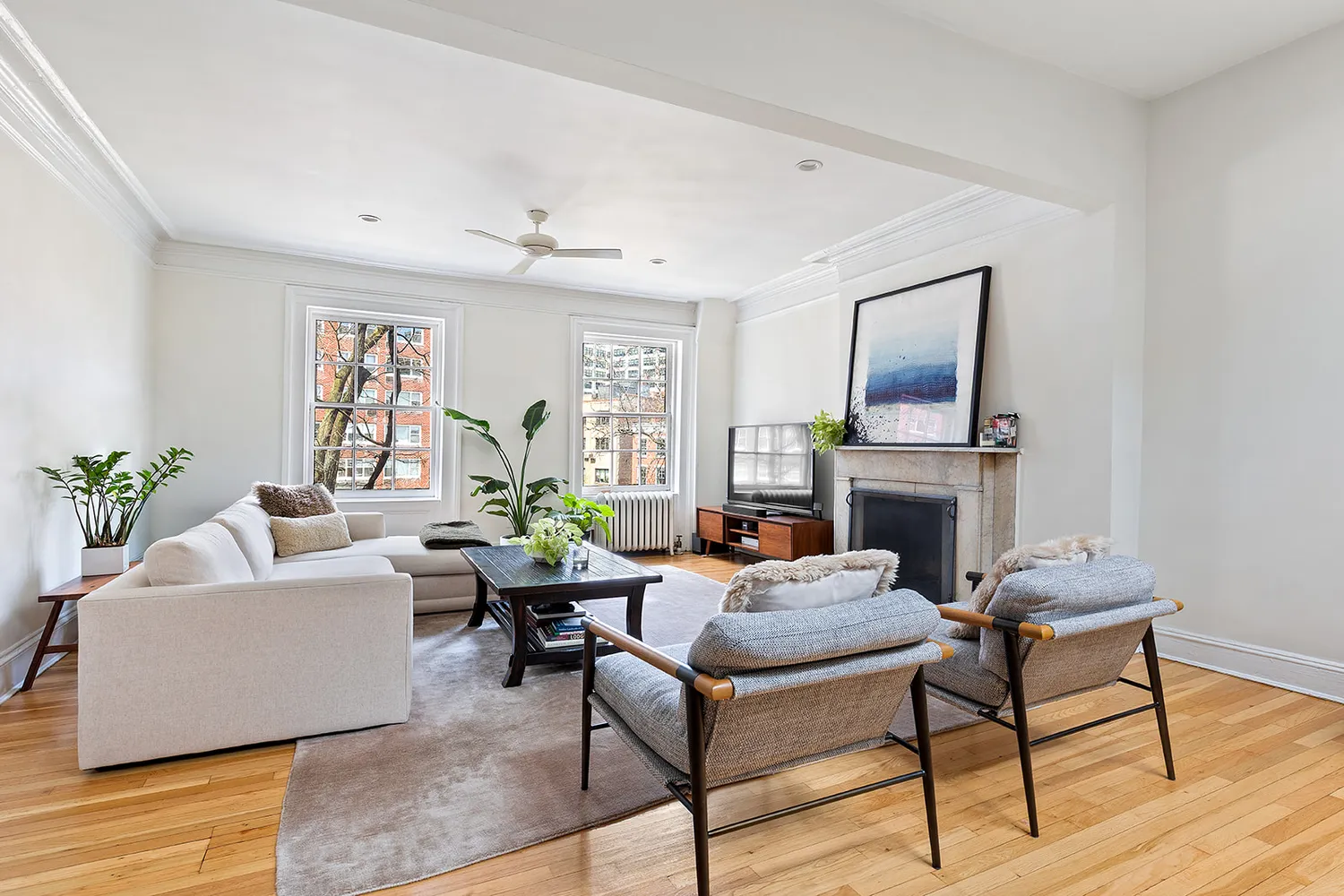 a living room with fireplace furniture and a wooden floor