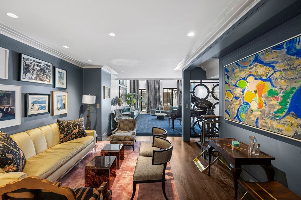 a living room with furniture and painting on the wall