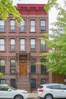 a front view of a building with parking space