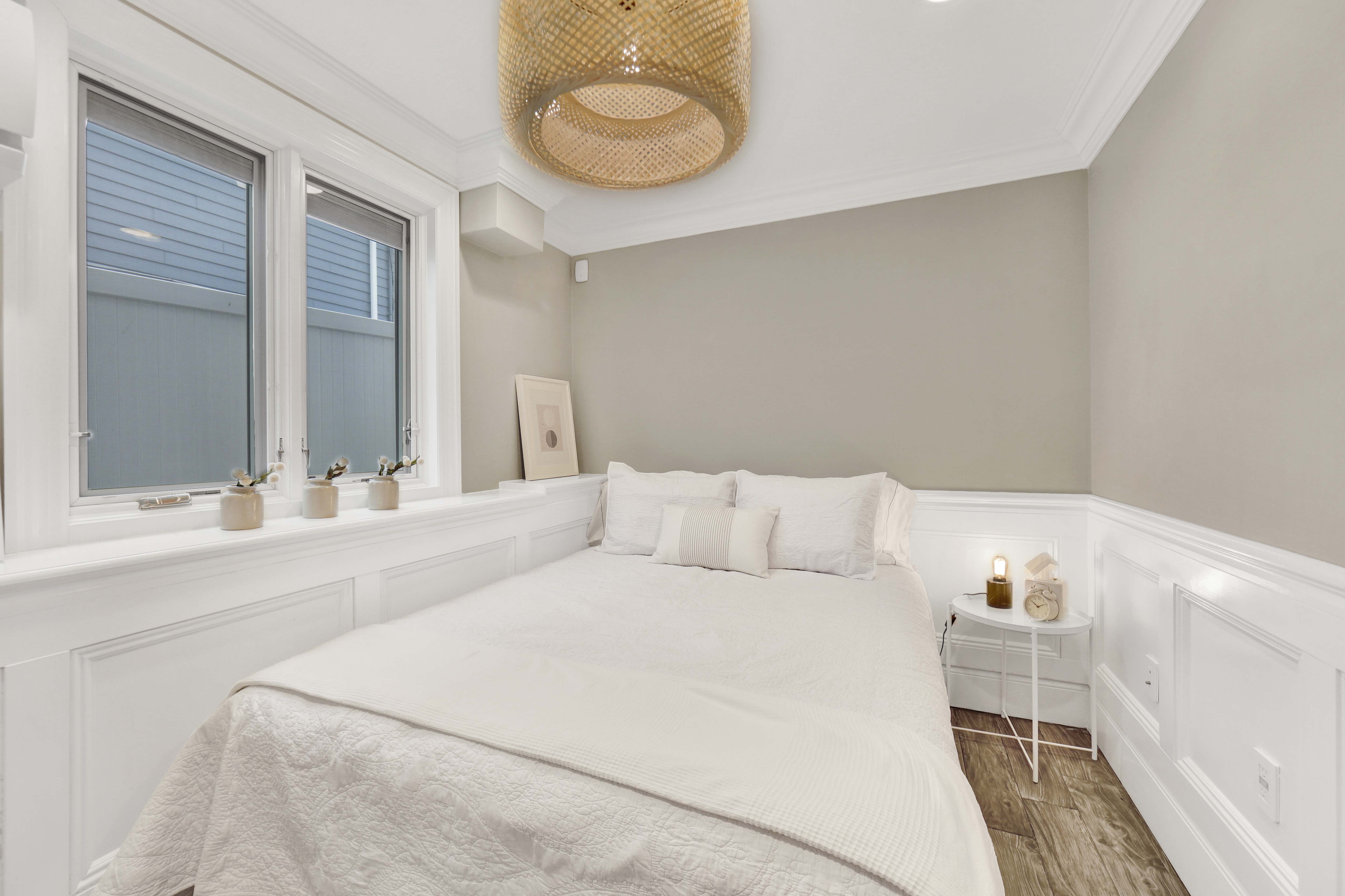 1-69 Beach 98th Street, Unit 1 Queens, NY 11694 - Photo 14 of 23 a bedroom with a bed and a chandelier