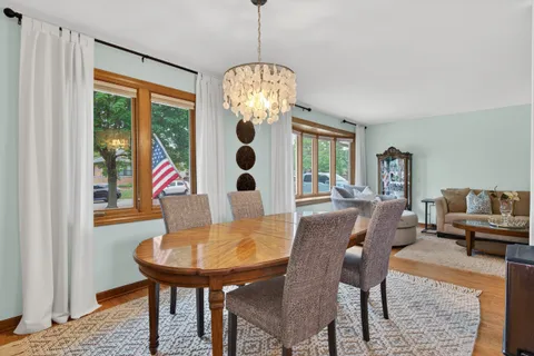 a view of a dining room with furniture and chandelier