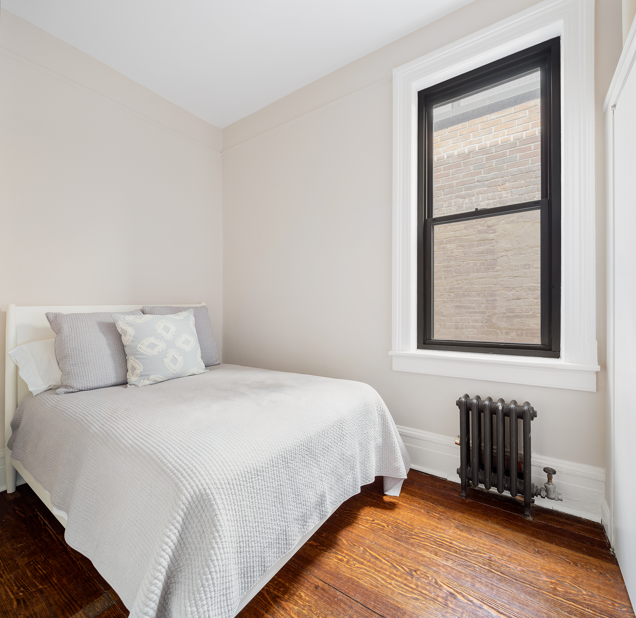 223 West 21st Street, Unit 5M Manhattan, NY 10011 - Photo 5 of 9 a bedroom with a bed and a window