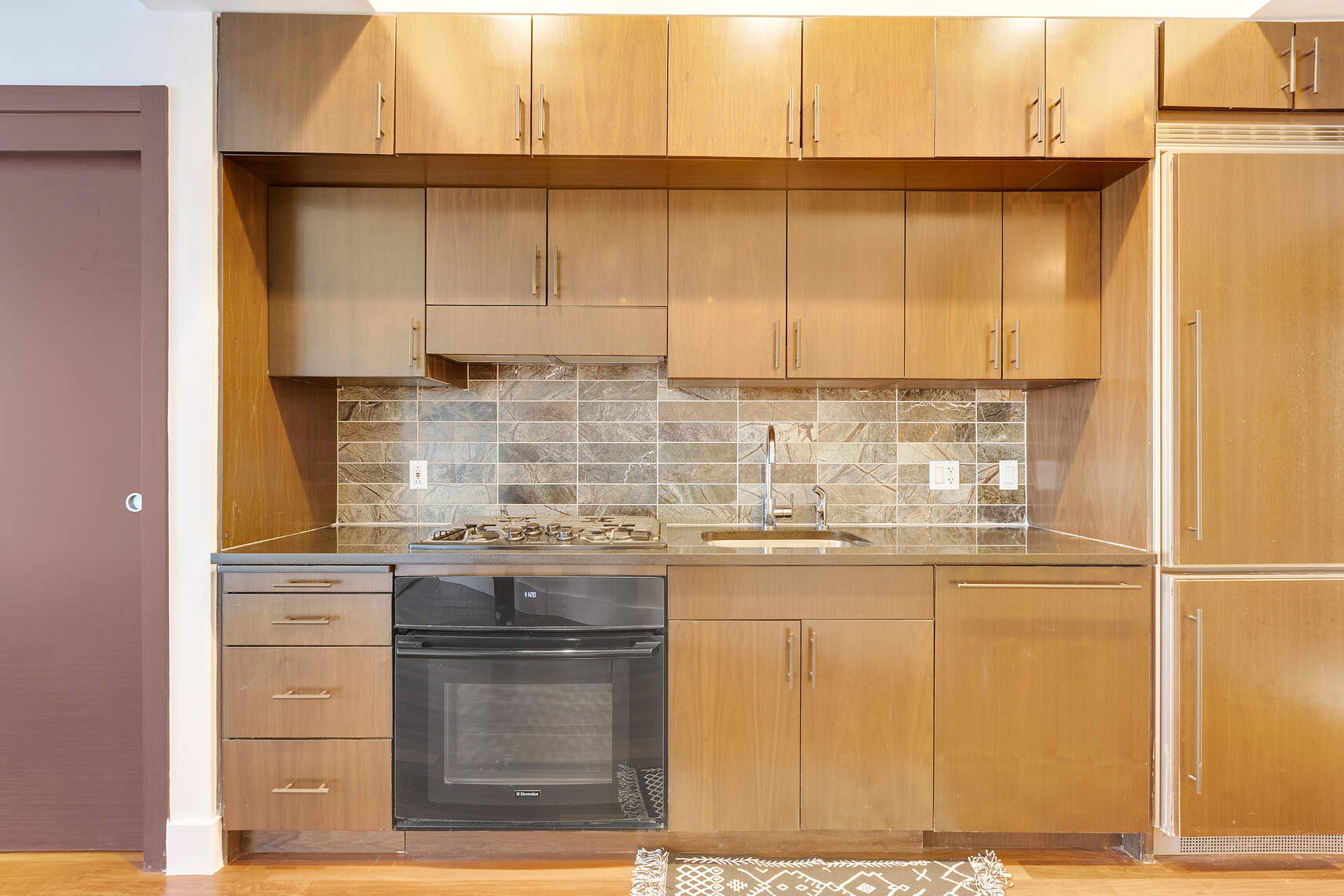 150 Myrtle Avenue, Unit 602 Brooklyn, NY 11201 - Photo 25 of 29 a kitchen with a sink cabinets and a wooden floor
