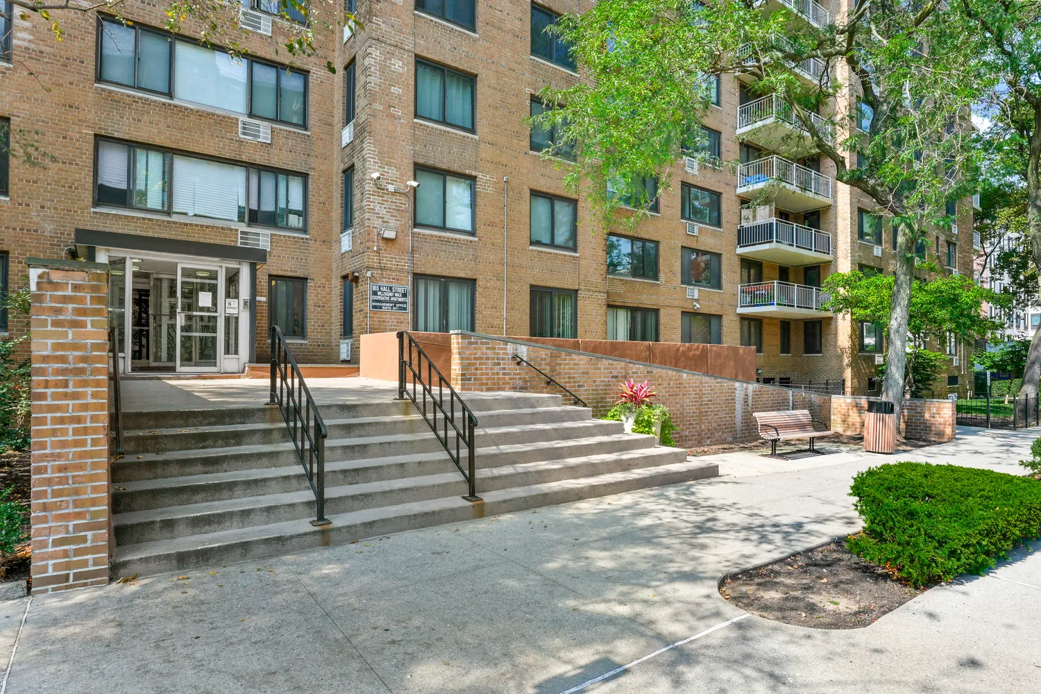 a view of a building with garden and sitting area
