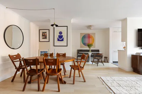 a view of a dining room with furniture and a chandelier