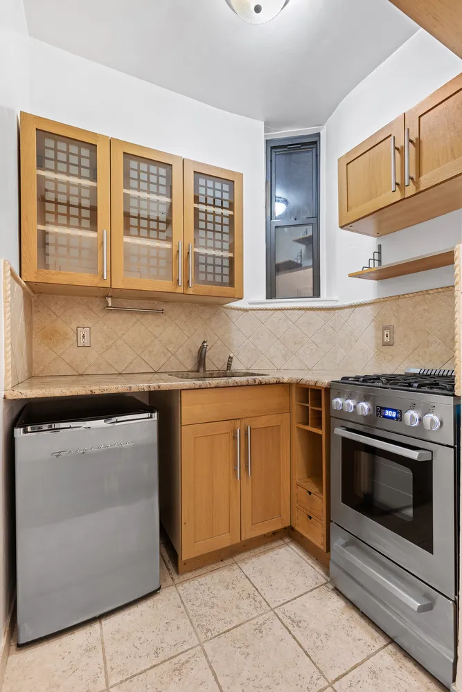 a kitchen with granite countertop cabinets stainless steel appliances and a sink