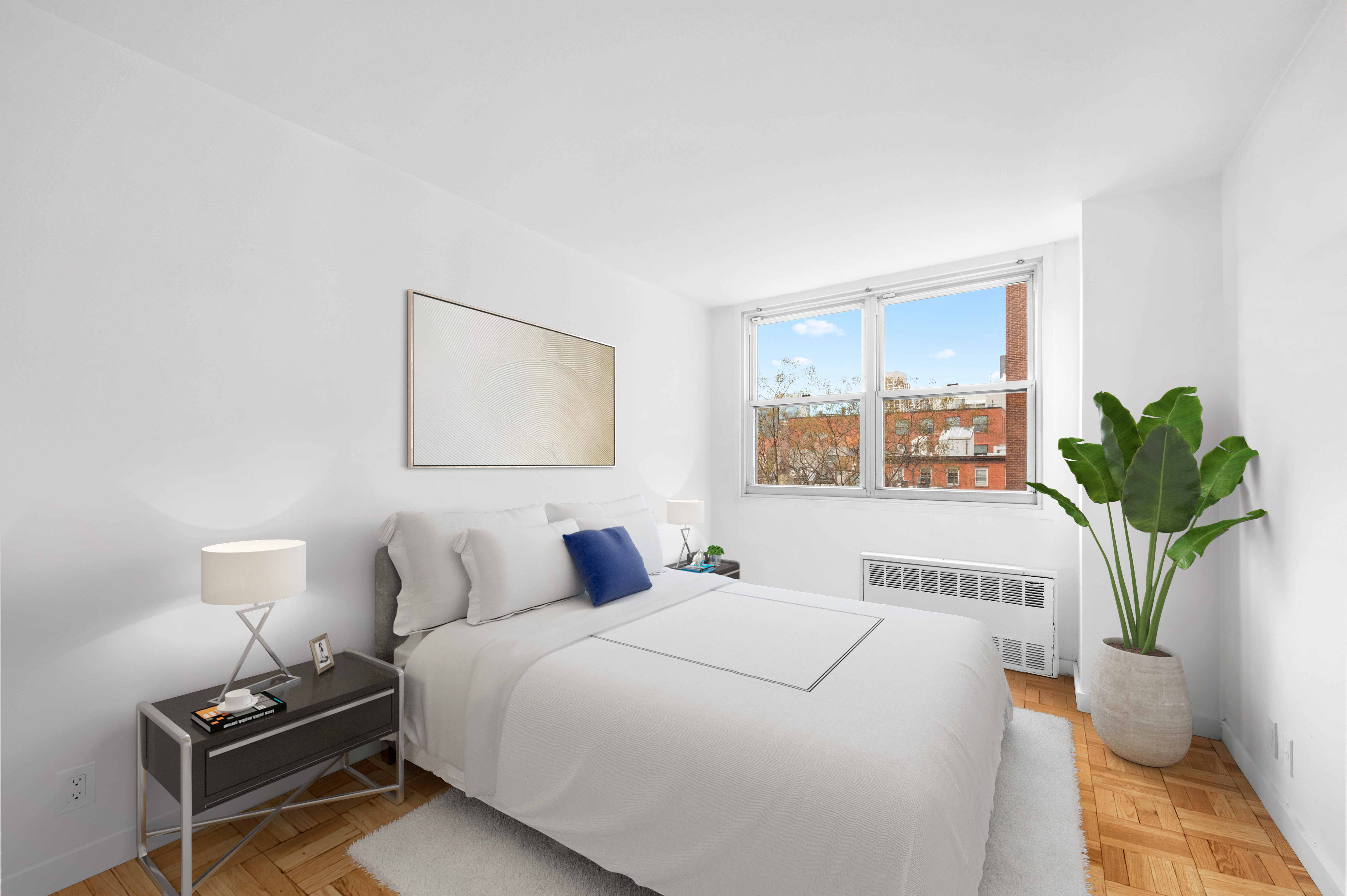 61 Jane Street, Unit 5A Manhattan, NY 10014 - Photo 3 of 13 a bedroom with a bed a mirror and a potted plant
