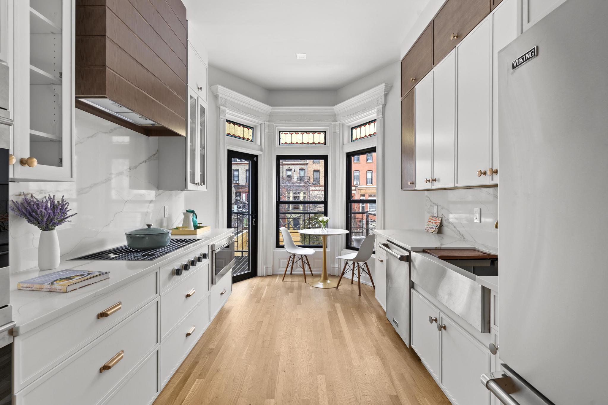 987 Sterling Place Brooklyn, NY 11213 - Photo 4 of 16 a kitchen with granite countertop a sink stove and cabinets