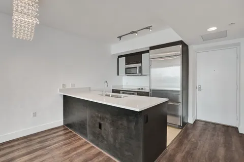 a kitchen with a sink and a mirror