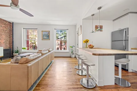 a kitchen with counter top space and wooden floor